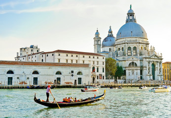 Fototapeta na wymiar View of the Basilica of Saint Mary of Health with Gondolas on the Grand Canal in Venice