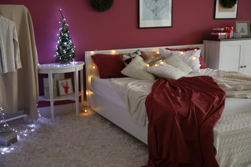 Modern bedroom with Christmas decor and cozy double bed