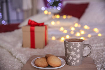 Obraz na płótnie Canvas Cookies and cup of hot drink on cozy double bed