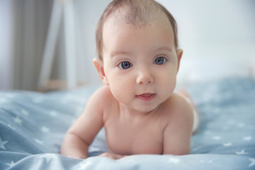 Cute baby lying on bed