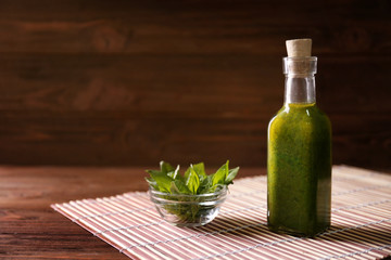 Bottle with oil on straw mat