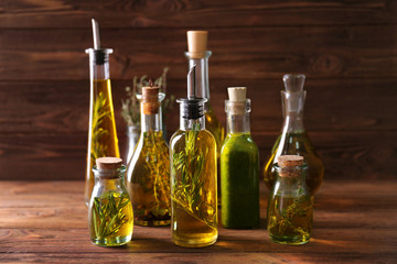 Composition of bottles with oil on wooden background