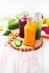Freshly squeezed vegetable juice in bottles, useful vitamin cocktail, detox diet, selective focus