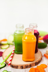 Freshly squeezed vegetable juice in bottles, useful vitamin cocktail, detox diet, selective focus