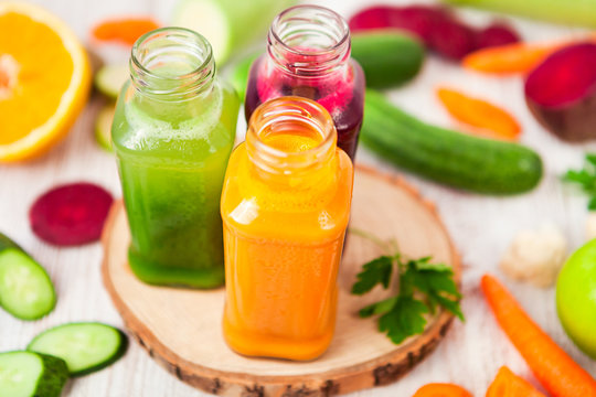 Freshly squeezed vegetable juice in bottles, useful vitamin cocktail, detox diet, selective focus