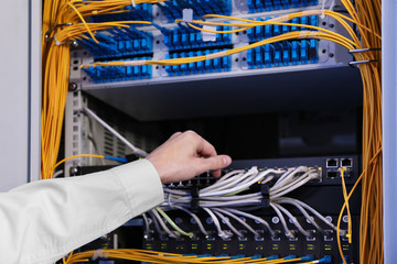 Handsome young engineer in server room