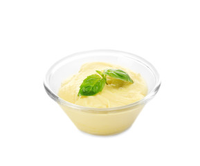 Creamy cheese and basil leaves in glass bowl, isolated on white