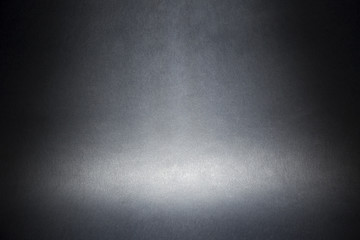 Scheinwerfer auf einem grauen materiellen abstrakten Hintergrund
