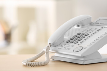 Telephone on wooden table in office