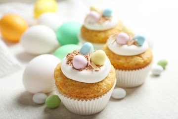 Decorated Easter cupcakes on linen tablecloth