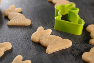 Raw rabbit shape Easter cookies on table