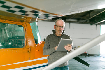 Flight instructor inspecting small Piper aircraft