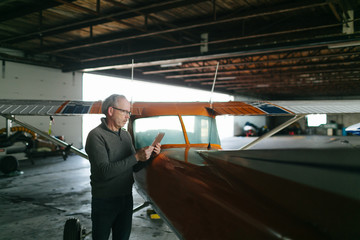 Flight instructor inspecting small Piper aircraft