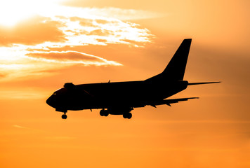 Airplane landing at sunset