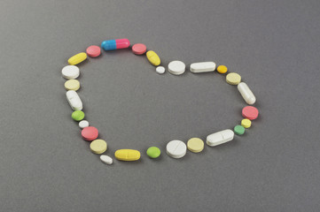 Heart created from colored pills. Medical concept