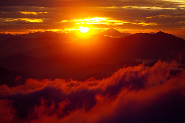 Orange sunset above mountain in valley Himalayas mountains