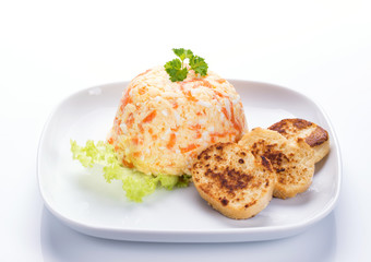 Cheese salad with carrot, eggs, garlic and mayonnaise, decorated with parsley and white bread toasts, white background