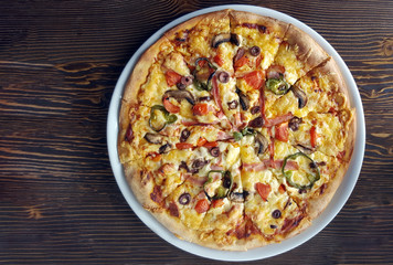 Tasty pizza on wooden table