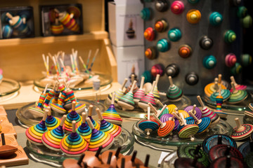 Market stall full of wooden spinning tops