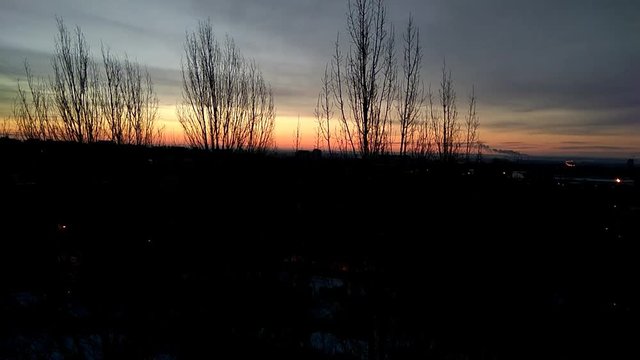 Colorful sky with clouds before sunrise over the city