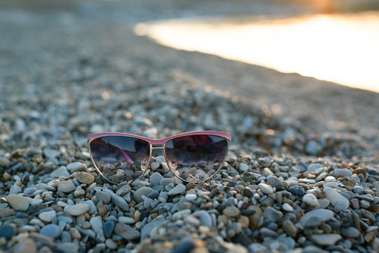 Pink Eye Glasses On The Sea Background