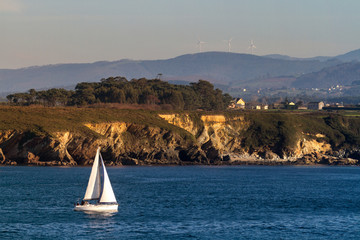 Sailboat off the rocky coast of Spain