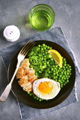 Healthy dinner bowl with green vegetables,roasted chicken and fried egg.Top view.