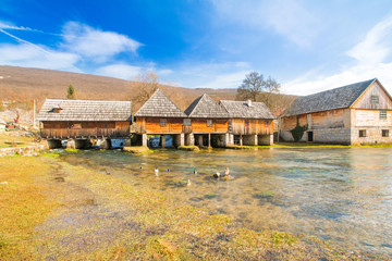 Fototapeta na wymiar Old wooden water mills in on Majerovo vrilo, source of Gacka river, Lika, Croatia 