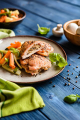Roasted chicken breasts stuffed with mushrooms, cheese and egg, garnished with steamed vegetable