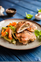 Roasted chicken breasts stuffed with mushrooms, cheese and egg, garnished with steamed vegetable