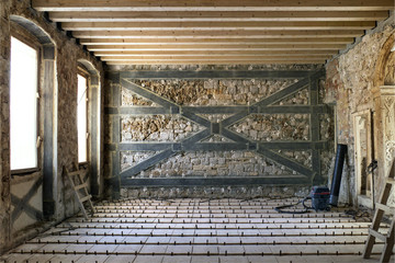 Renovation of old medieval house with injecting walls with special material and reinforcement with...