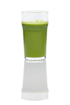 Glass of fresh kiwi, celery and apple juice with reflection on white background