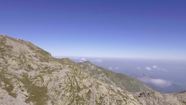 Italy Alps mountains aerial on rocky side in summer sunny day. 4k drone side flight wide establishing shot