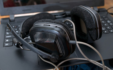 Fototapeta na wymiar Black large dj headphones left on the laptop after mixing music