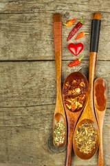Dried chili peppers on a wooden spoon. Sale of spices. Advertising for sale. Different kinds of hot peppers.