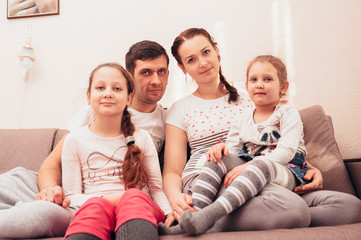 Happy family at home on the couch