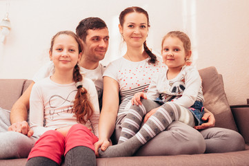 Happy family at home on the couch