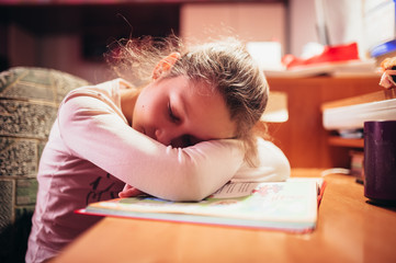 The girl fell asleep on the textbook