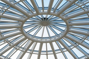 Glass dome of a modern building. View from the inside of the room. Light construction of transparent roof made of round steel tubes. Architectural background