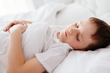 Fototapeta na wymiar Little boy child sleeping in bed
