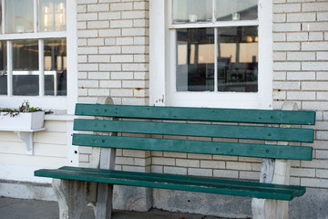 Green Bench against white brick
