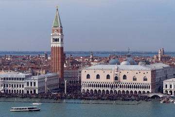 Obraz premium Aerial view of the Piazza San Marco with the Campanile and Doge's Palace and huge crowds of people at Carnival in Venice - landscape