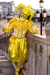 Carnival in Venice - yellow costume makes the clown eye-catching