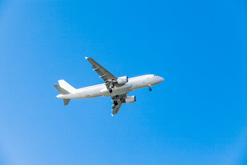 Fototapeta na wymiar white airplane on a blue background. airplane in the sky
