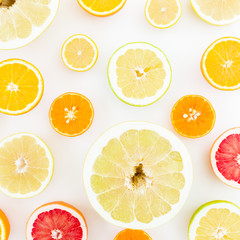 Citrus fruits pattern made of lemon, orange, grapefruit, sweetie and pomelo on white background. Flat lay, top view.