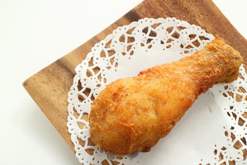 Homemade fried chicken drum stick on wooden plate