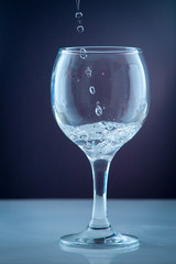 Pure water pouring into a transparent glass