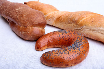 Assorted fresh breads isolated on a white background.