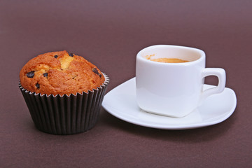 Classic espresso in white cup with cake and chocolate.
