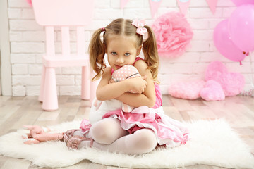 Little cute girl with party decor on brick wall background